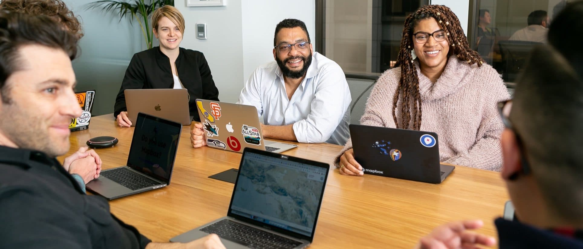 A group of people collaborating around a table in an office.