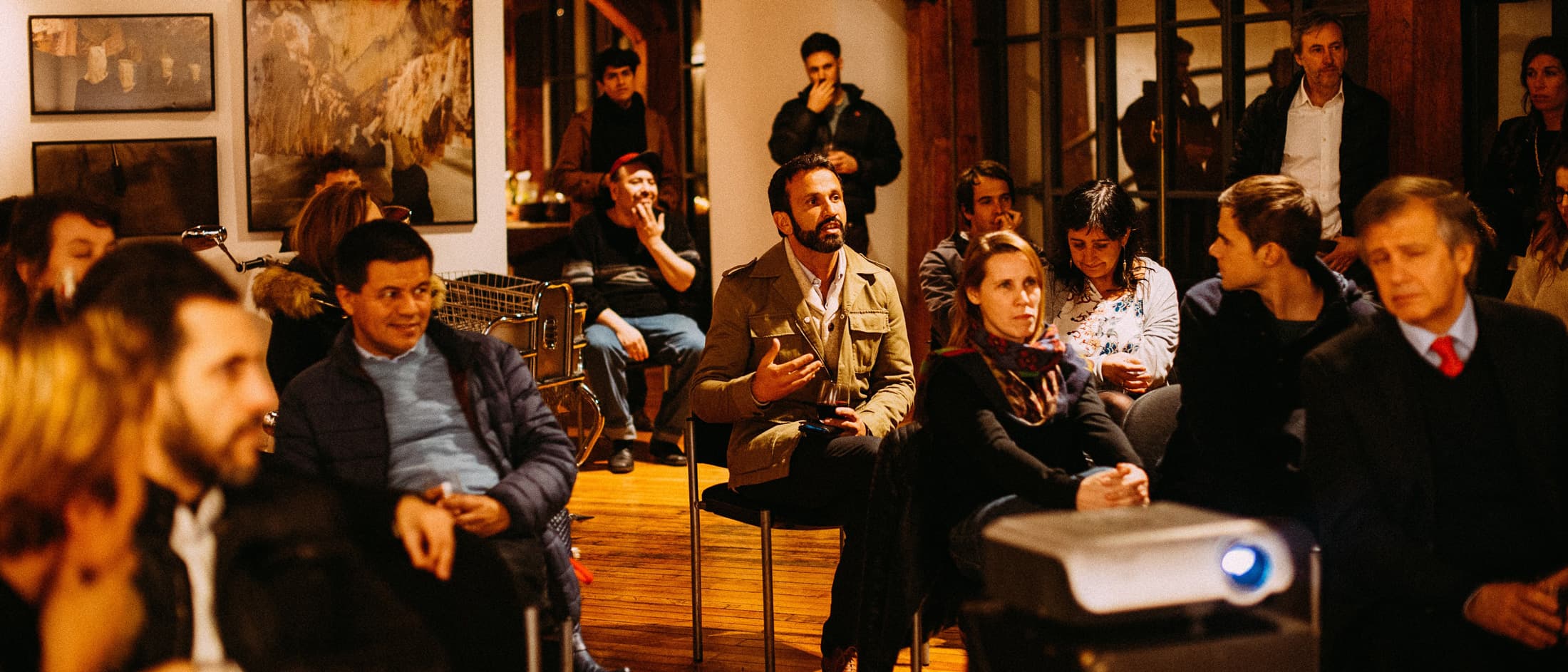 Group of people sitting in a room and one is talking