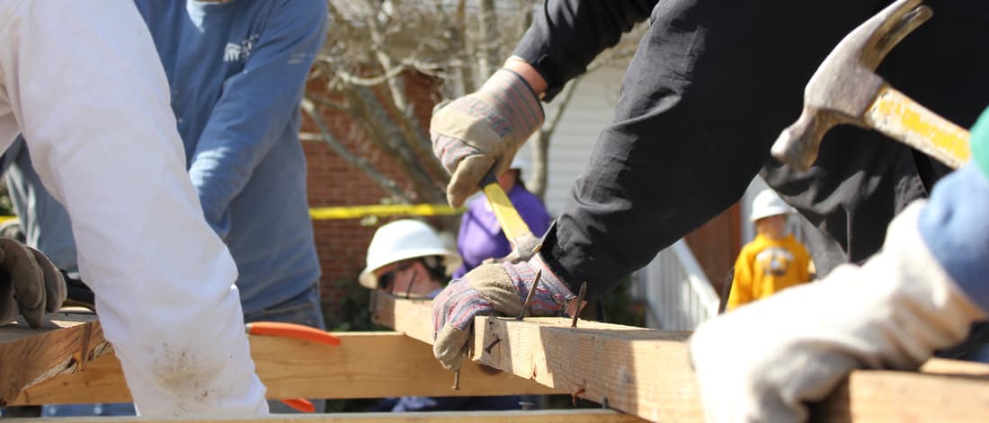 Construction workers using hammers to hammer nails