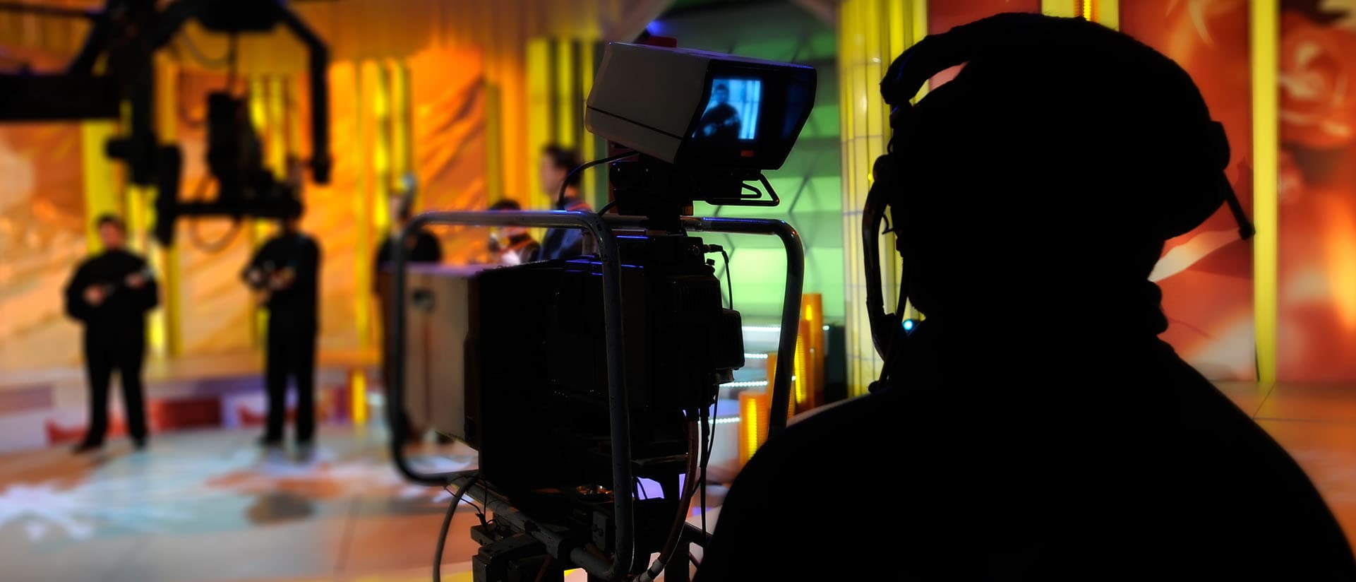An individual behind a video camera