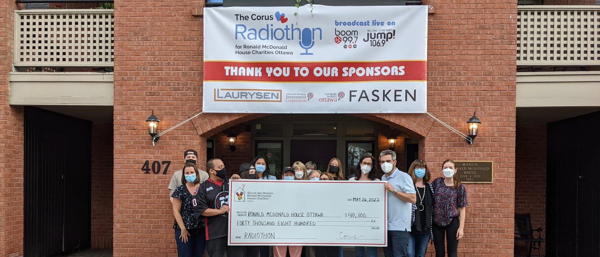 People standing and holding a presentation check