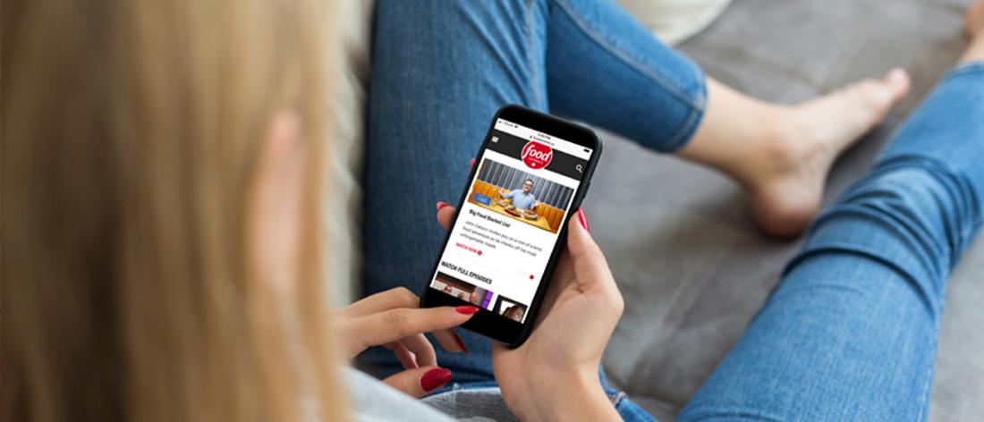 Woman looking at Food Network site on phone