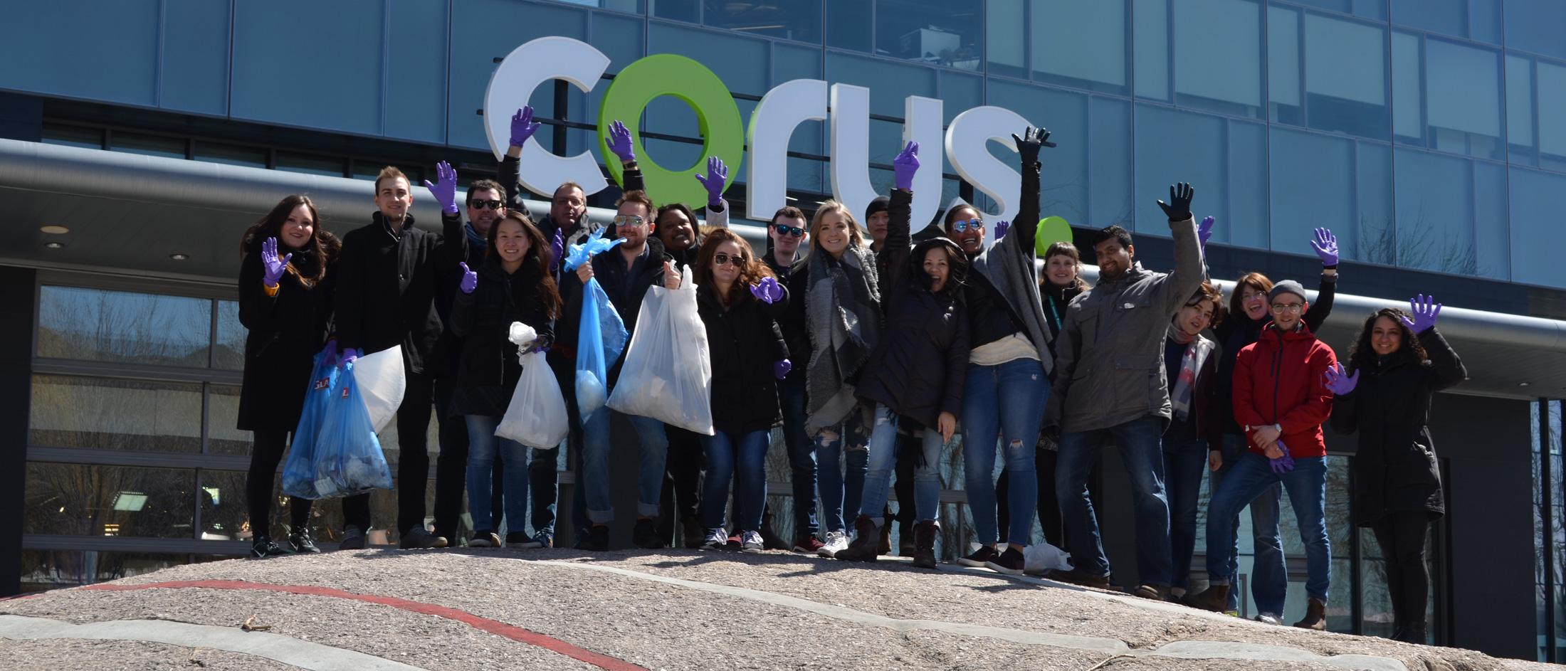 people standing in front of corus building